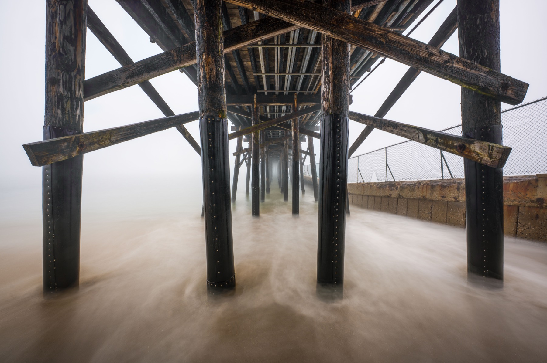 Fog and moving water under the Seal Beach pier