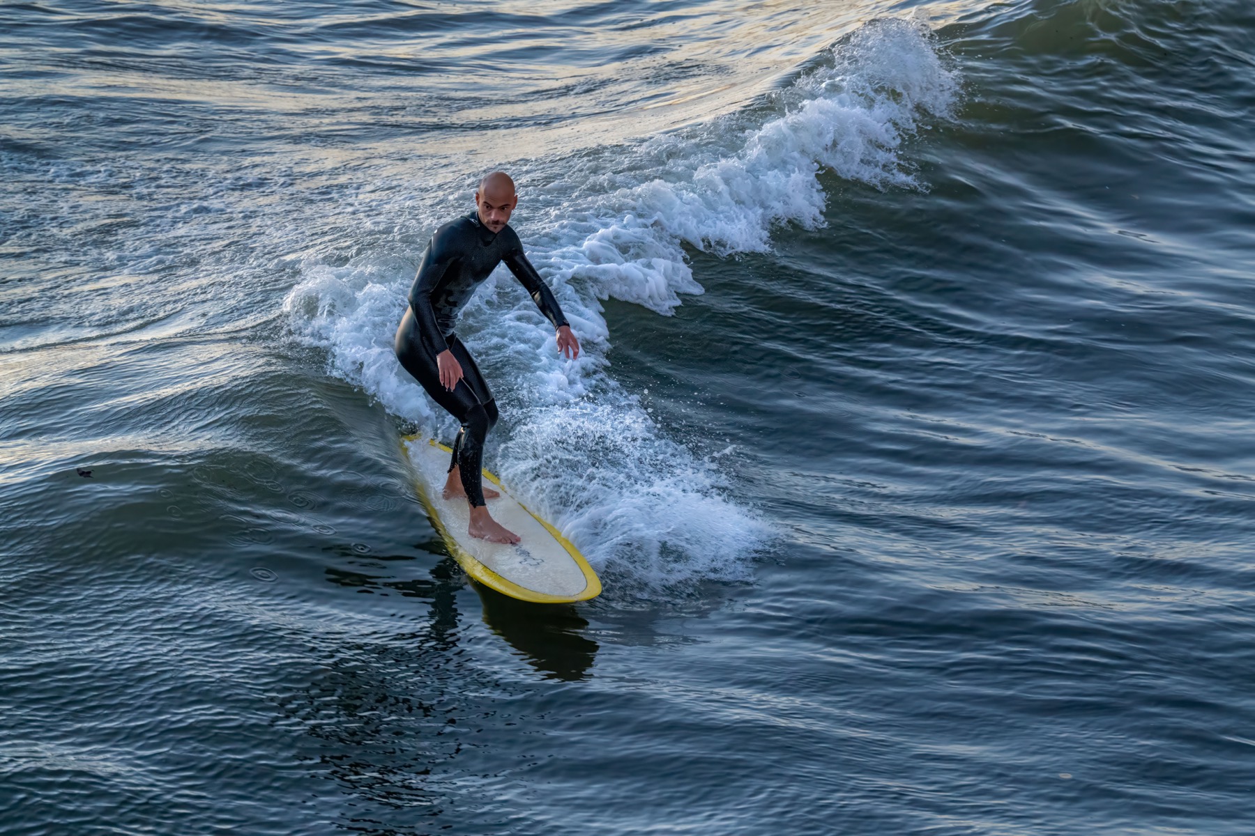 Surfer riding a wave near Seal Beach